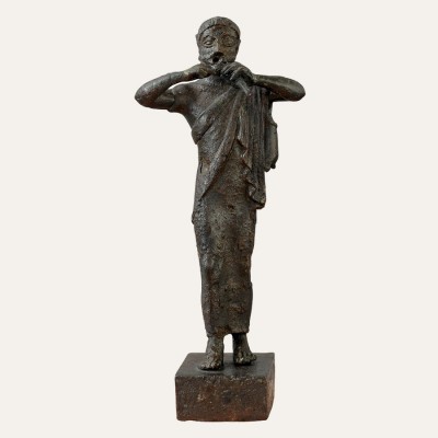 Bronze male figurine of a flute-player (5he century B.C.), Delfi Archaeological Museum.